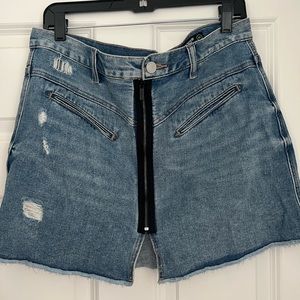 Blank denim mini skirt. Like new, wore once. Cute zipper  detail in the front.